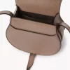 Small Marcie saddle bag in shiny leather